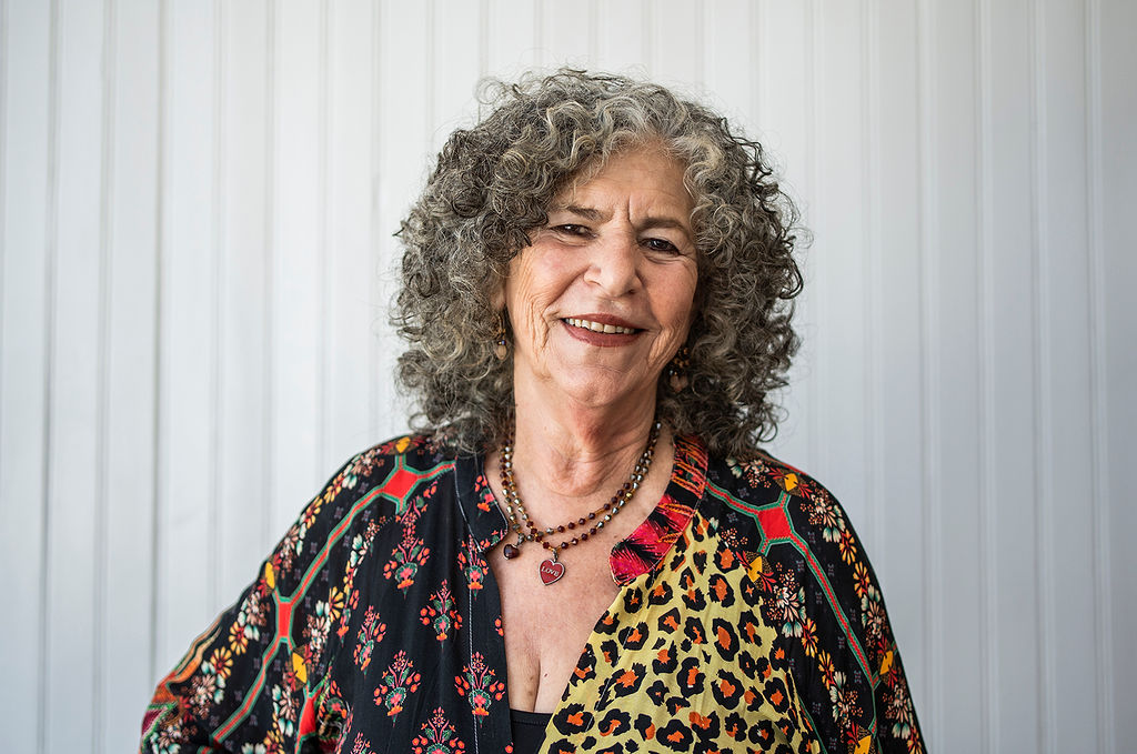 Shifra Jacobson smiling, wearing a brightly patterned shirt